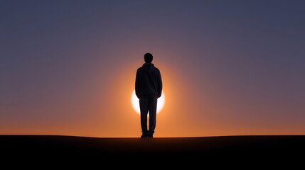 Fototapeta premium Silhouette of a person standing before a glowing horizon