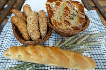 Fresh, delicious baked goods made in a bakery. Bread, baguette, bun, croissant, cake. Healthy, light, modern food.