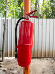 Fire Extinguisher on Construction Site Pole.