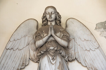 Ancient statue of angel in Italian old cemetery. Religious sculpture, no people, grey marble