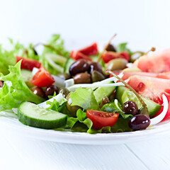 Healthy and tasty salad with , various tomatoes, olives, cucumber, onion and lettuce.	