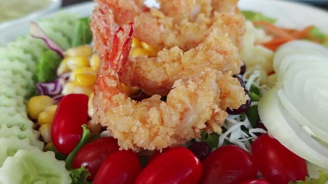 Fried shrimps tempura and fresh salad