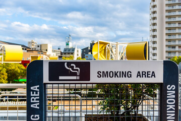 Smoking area sign at public park.