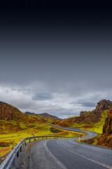 Cover page with a paved road, Ring road, through rough and colorful Icelandic landscape, Iceland, summer, dramatic scene, copy space