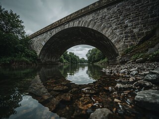 Stone Bridge over Calm River on Overcast Day