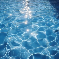 Sunlit ripples on a clear blue swimming pool surface.