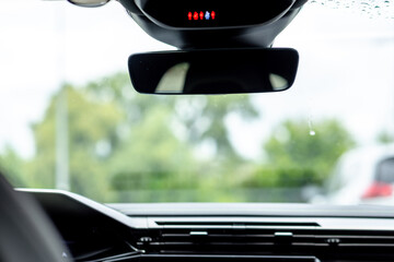 Close-up of a Car's Interior with Focus on the Rearview Mirror