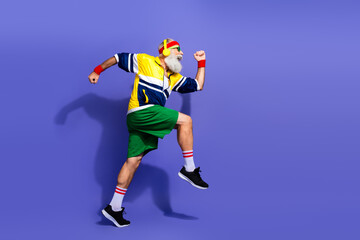 Vibrant portrait of an elderly man exercising in retro sportswear showing energy and vitality