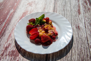 Delicious homemade strawberry bars with red topping at wooden table