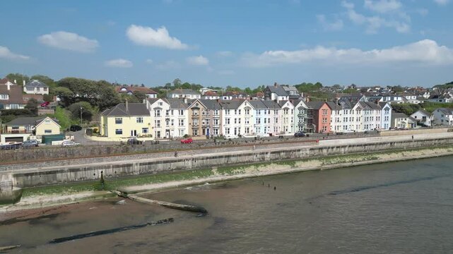 Dawlish, Devon, England: DRONE VIEWS: An Intercity train passes a row of Victorian terrace houses on the seafront. Dawlish is a popular UK holiday destination on route to west Devon and Cornwall. 