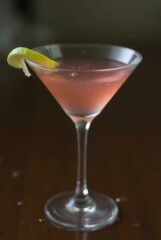 Cosmopolitan Cocktail: A beautifully presented cosmopolitan cocktail, elegantly garnished with a lemon twist, inviting you to savor its sophisticated taste and refreshing essence.