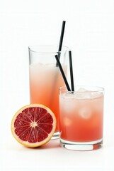 Citrus Sunrise: A refreshing composition of two cocktails featuring a vibrant mix of blood orange juice, served with ice and straw. A half cut blood orange is next to them.
