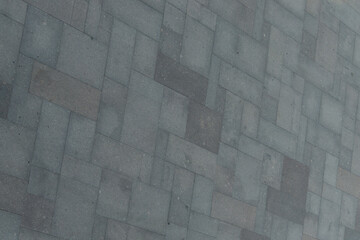 Perfect gray paving slabs. Road surface from blocks of different sizes. Gray geometric background.