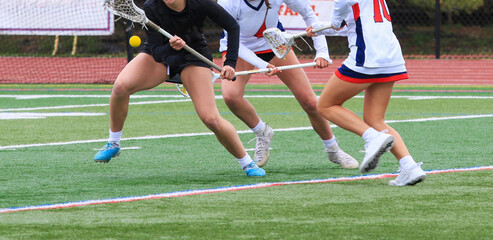 Female Lacrosse Players Engage in Competitive Play on Turf Grassy Field