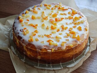 Cheesecake with icing and candied orange peel