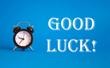 Good luck symbol. Beautiful blue background with alarm clock. Business and Good luck concept. Copy space.