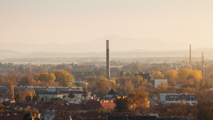 Outskirts of Graz at sunset - cityscape. Aerial view from Schlossberg with roofs and chimneys of mixed use at sunset. Graz, Austria - November 01, 2013