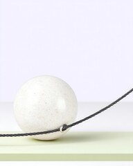White Sphere Balanced on a Thin Black Line