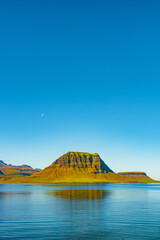 Cover page with a Kirkjufell Mount and ocean, colorful Icelandic landscape, Iceland, summer, suny blue sky, copy space