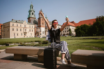 Tourist taking selfie in wawel castle, krakow, poland
