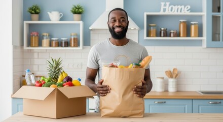A smiling young Black man unpacks groceries in his modern kitchen, promoting healthy eating and a happy home life.