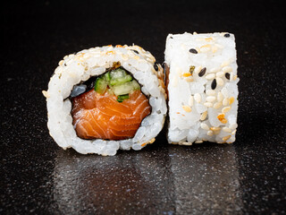 Discover the art of sushi making with beautifully crafted rolls featuring salmon and vegetables
