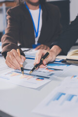 Focused young businessman signing agreement with skilled lawyer in eyeglasses. Concentrated financial advisor showing place for signature on paper contract document to male client at meeting in office