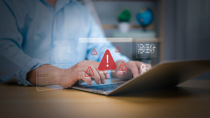 Cybersecurity, virus protection, Hand on laptop with holographic System warning and red alert icons. Symbolizes cyber threats, data security breaches, and IT system errors. digital risk management now