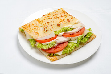Layers of turkey, lettuce, and tomato create a mouthwatering dish in a cozy kitchen environment