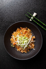 Enjoy the vibrant textures and flavors of special fried rice topped with fresh veggies
