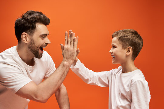 Celebrating fatherhood with joyful high fives on a warm father day occasion in 2025
