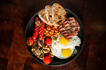 Feasting on a hearty breakfast with sunny-side-up eggs, crispy bacon, and grilled mushrooms