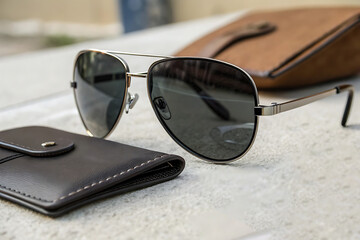 Stylish black sunglasses, a quintessential summer fashion accessory, offer essential eye protection whether on the beach or a table
