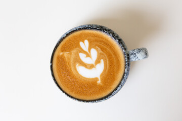 Close up shot of hot coffee latte art on wood table in cafe