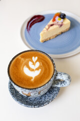 Close up shot of hot coffee latte art on wood table in cafe