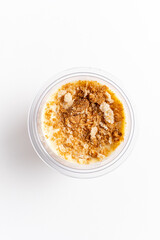 Creamy dessert delights with layers of sweetness and a crunchy crumble on top, awaiting enjoyment