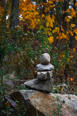 Stacked Stones Balanced in Autumn Forest, Symbol of Mindfulness