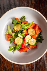 A vibrant bowl of fresh greens, zucchini, and bell peppers showcasing colorful textures