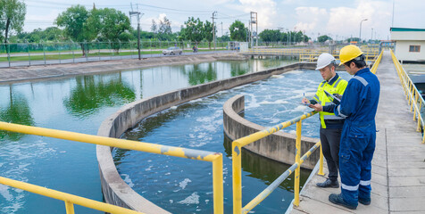 Environmental engineers work at wastewater treatment plants,Water supply engineering working at Water recycling plant for reuse,Technicians and engineers discuss work together.