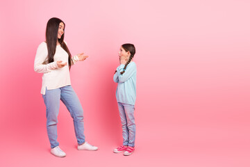 Mother and daughter bonding on a pink background emphasizing family values and happy moments