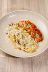 Savory pasta dish served with seasoned chicken on a rustic wooden table