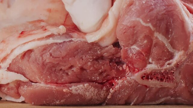 Fresh Raw lamb meat leg with herbs and spices, mutton meat. Chef cooking cutting meat for dinner in restaurant, cafe. Work with knife on kitchen.