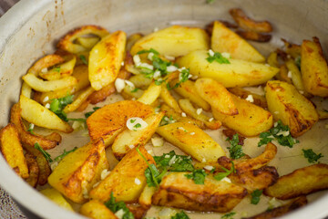 Appetizing baked potatoes with garlic and herbs