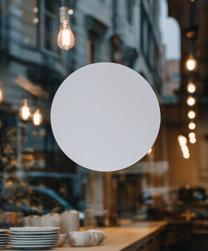  blank white round sticker on a window