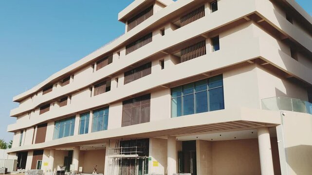 Modern design Aluminum shape Multi Baffle Cladding Decoration. Balcony Facade Architecture Panel with Black Horizontal Metal, Wood stripes. Exterior view multistory building with black glass windows.