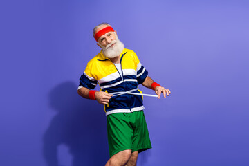 Funny man in colorful retro tracksuit measuring waistline, adopting a healthy fitness lifestyle...