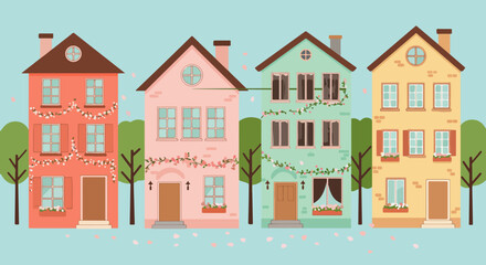 Row of four pastel-colored houses with unique architectural details and green trees