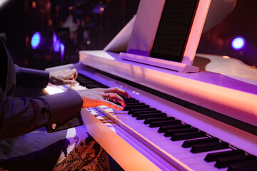 Hands Playing a White Digital Piano