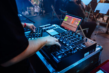 DJ or Sound Engineer Working on a Console