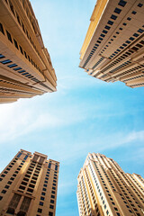 Abstract architectural image with skyscrapers on sky background.